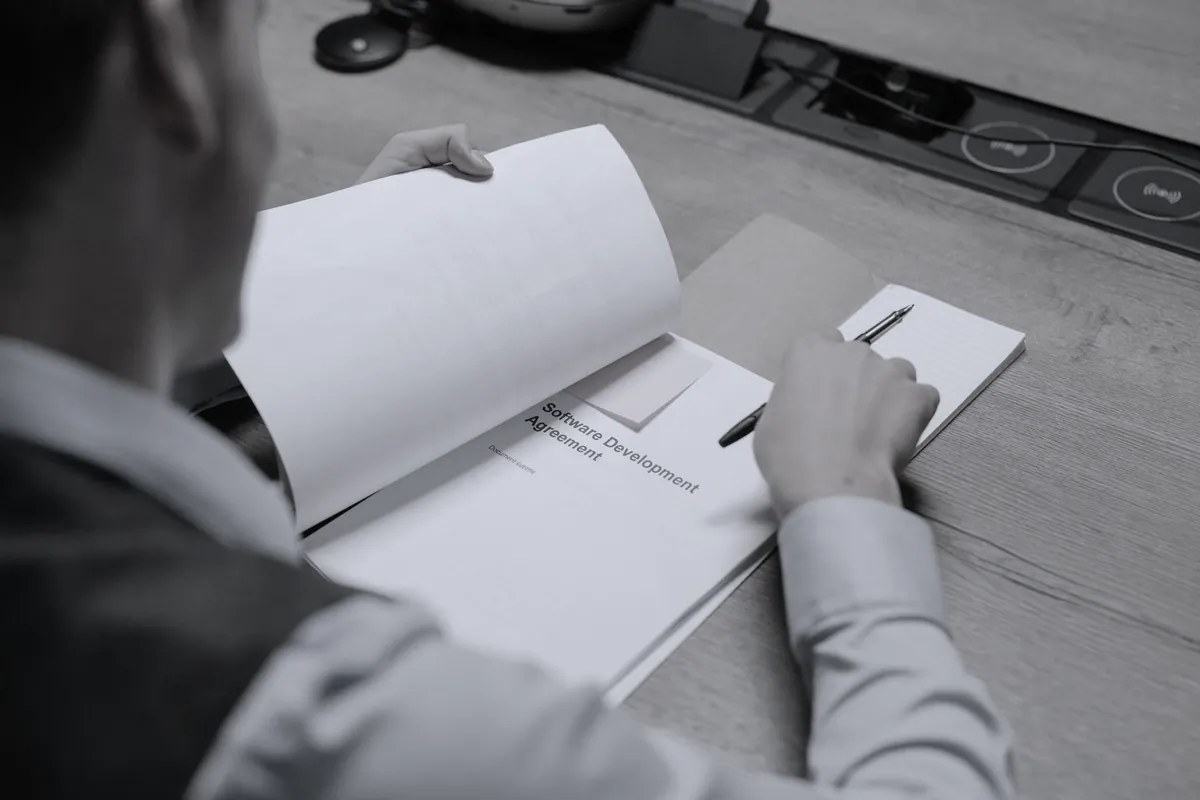 Reports and spreadsheets being checked and annotated on a desk
